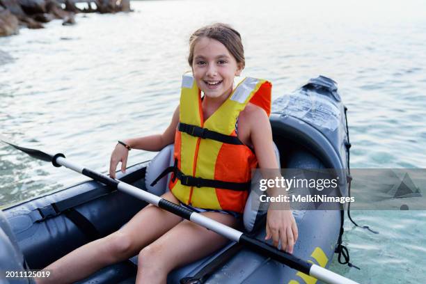 girl having fun with inflatable kayak on her summer cam vacation - cam girl stock pictures, royalty-free photos & images