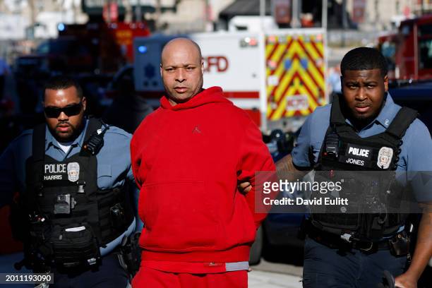 Man is detained by law enforcement following a shooting at Union Station during the Kansas City Chiefs Super Bowl LVIII victory parade on February...