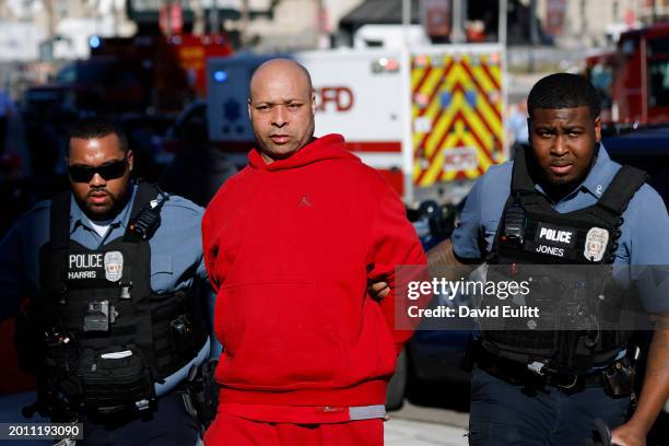 Man is detained by law enforcement following a shooting at Union Station during the Kansas City Chiefs Super Bowl LVIII victory parade on February...