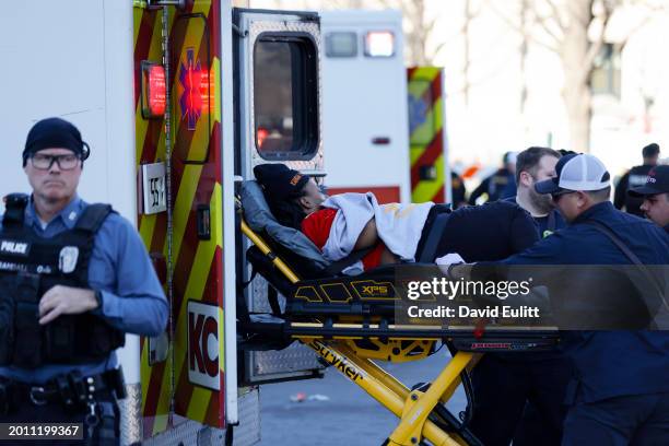 Person is loaded onto an ambulance following a shooting at Union Station during the Kansas City Chiefs Super Bowl LVIII victory parade on February...