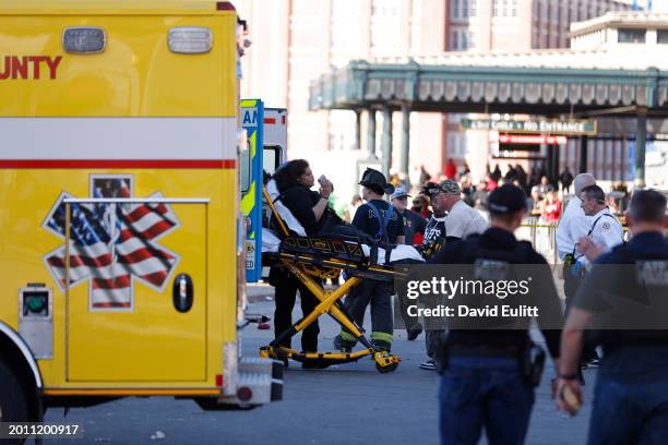 Person is loaded onto an ambulance following a shooting at Union Station during the Kansas City Chiefs Super Bowl LVIII victory parade on February...