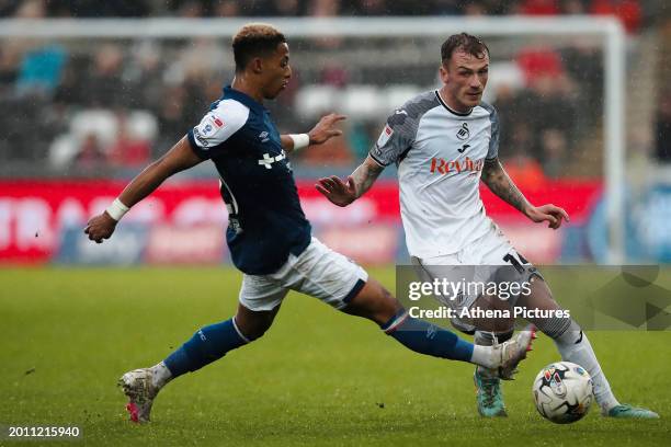 Omari Hutchinson of Ipswich Town challenges Josh Tymon of Swansea City during the Sky Bet Championship match between Swansea City and Ipswich Town at...