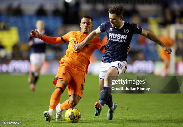 Ali Al-Hamadi of Ipswich Town is challenged by Ryan Leonard of Millwall during the Sky Bet Championship match between Millwall and Ipswich Town at...