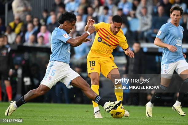 Barcelona's Brazilian forward Vitor Roque vies with Celta Vigo's Peruvian midfielder Renato Tapia during the Spanish league football match between RC...