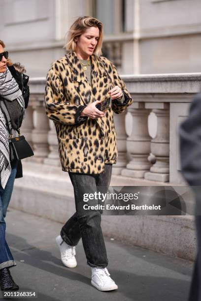 Guest wears a beige and black animal-print / leopard print pattern fluffy oversized blazer jacket , a gray top, a golden necklace, black denim jeans...