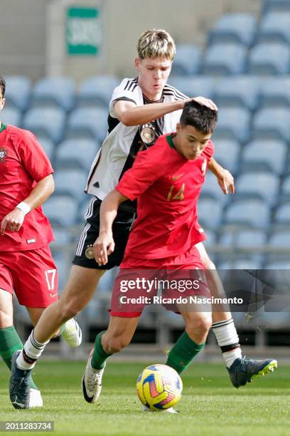 Denis Husser of U17 Germany challenges Afonso Sousa of U17 Portugal during the Portugal U17 v Germany U17 - Algarve Cup match on February 14, 2024 in...