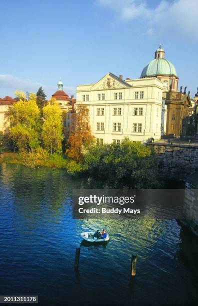 Small fishing boat floating on the Vltava River in downtown Prague, Czech Republic, eastern Europe, 2013. .
