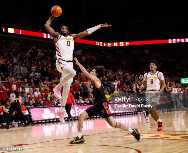 Tre King of the Iowa State Cyclones takes a shot as Pop Isaacs of the Texas Tech Red Raiders defends while Curtis Jones of the Iowa State Cyclones...