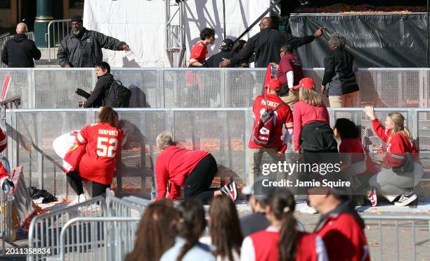 People take cover during a shooting at Union Station during the Kansas City Chiefs Super Bowl LVIII victory parade on February 14, 2024 in Kansas...