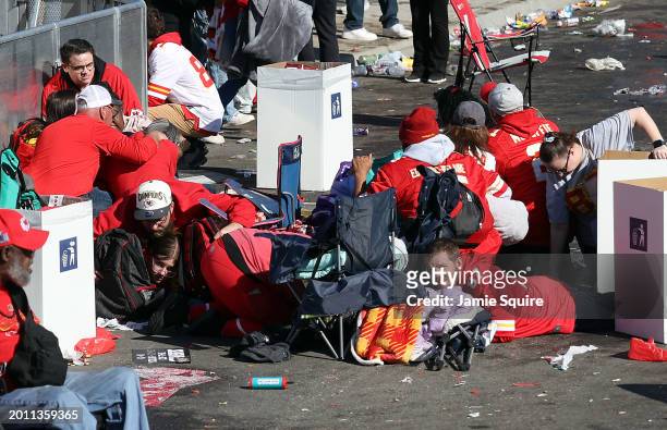 People take cover during a shooting at Union Station during the Kansas City Chiefs Super Bowl LVIII victory parade on February 14, 2024 in Kansas...