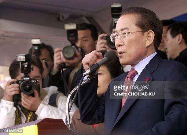 Lee Hoi-Chang, a former prime minister and supreme court justice gestures as he speaks in front of journalists during the presidental election...