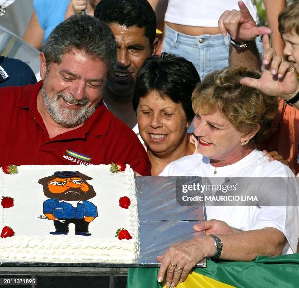 Luis Inacio Lula da Silva, presidential candidate of Brazil for the Worker's Party, next to his wife Marisa da Silva, receives a cake which has a...