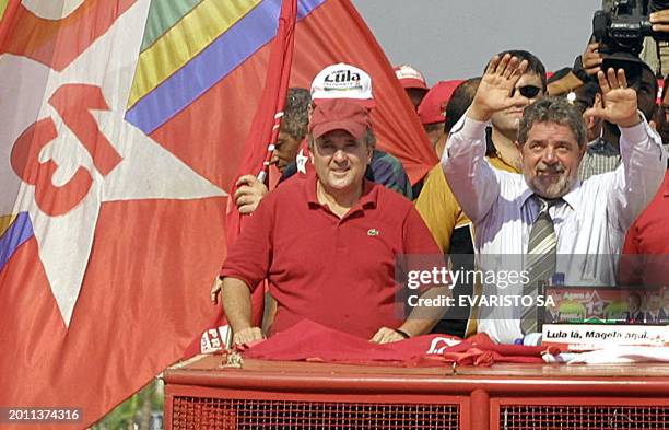 Luis Inacio Lula da Silva, presidential candidate of Brazil for the Worker's Party, greets his supporters while riding a truck during a electoral...