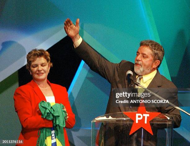 Brazilian Workers' Party presidential candidate Luiz Inacio Lula da Silva, accompanied by his wife Marisa, speaks 21 October during a meeting with...