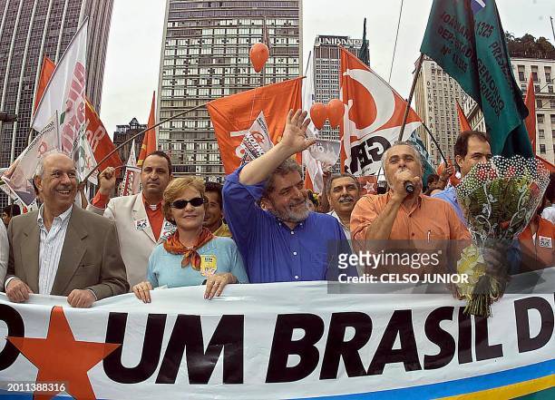 Brazilian presidential candidate for the Workers Party, Luis Inacio Lula da Silva , greets supporters during a parade through the streets of Sao...