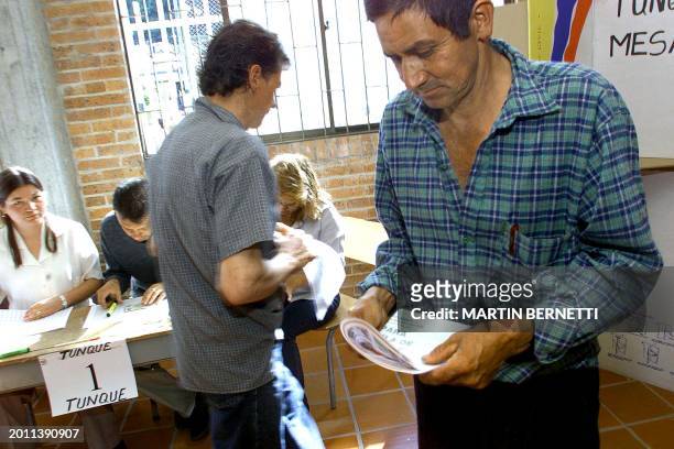 Farmer gets ready to vote with his ballot in hand, at a polling station in Bogota, Colombia, 26 May 2002. War-weary Colombians went to the polls 26...