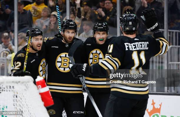 James van Riemsdyk of the Boston Bruins celebrates with teammates Derek Forbort, Trent Frederic and Kevin Shattenkirk after he scored his first of...