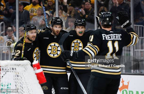 James van Riemsdyk of the Boston Bruins celebrates with teammates Derek Forbort, Trent Frederic and Kevin Shattenkirk after he scored his first of...