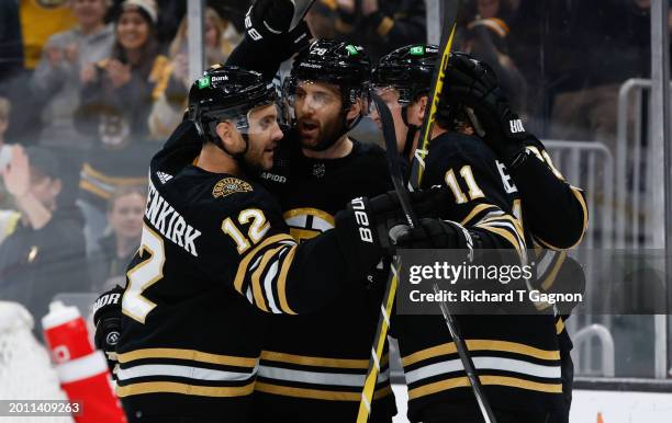 James van Riemsdyk of the Boston Bruins celebrates with teammates Derek Forbort, Trent Frederic and Kevin Shattenkirk after he scored his first of...