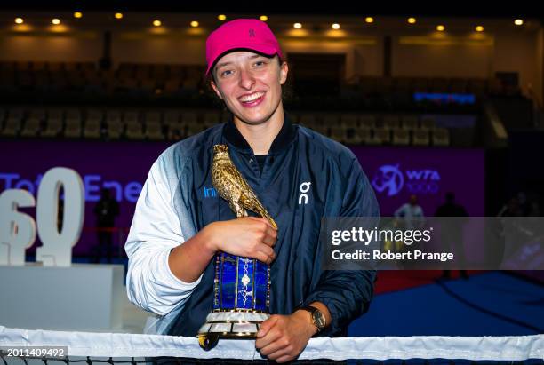 Iga Swiatek of Poland poses with the champions trophy after defeating Elena Rybakina of Kazakhstan in the singles final on Day 7 of the Qatar...