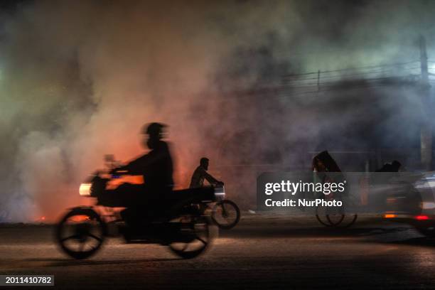 City dwellers are passing by a garbage fire on a busy road in Dhaka, Bangladesh, on February 17, 2024. Five of the top 10 causes of death in...