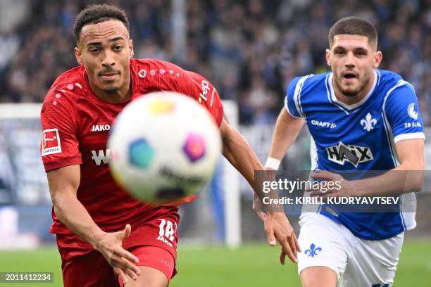 Stuttgart's German forward Jamie Leweling and Darmstadt's Austrian defender Emir Karic vie for the ball during the German first division Bundesliga...