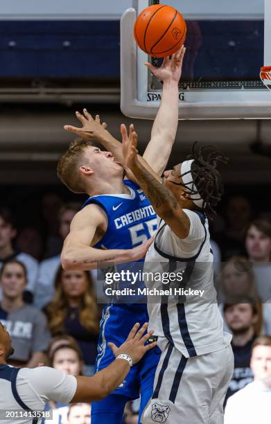Baylor Scheierman of the Creighton Bluejays shoots the ball against Jalen Thomas of the Butler Bulldogs during the second half at Hinkle Fieldhouse...