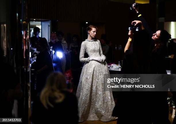 Model poses in the backstage ahead of a catwalk presentation by British designer Richard Quinn for his Autumn/Winter 2024 collection during London...