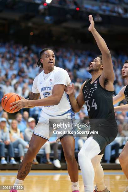 North Carolina Tar Heels forward Armando Bacot looks to pass as Virginia Tech Hokies forward Mylyjael Poteat defends during the college basketball...