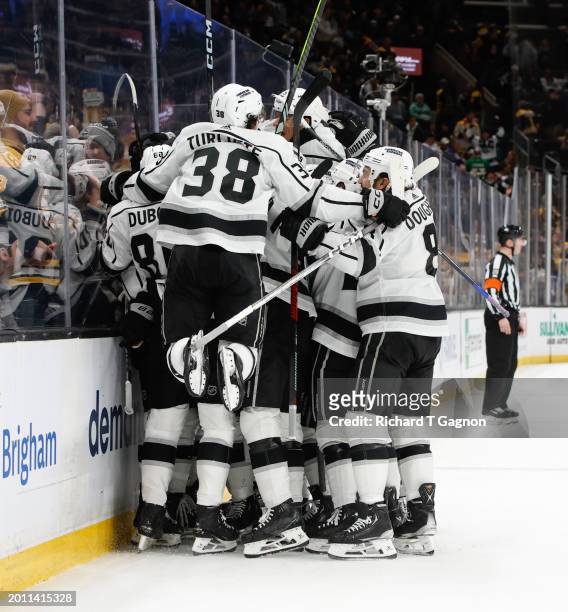 Brandt Clarke of the Los Angeles Kings celebrates with his teammates after he scored in overtime against the Boston Bruins at the TD Garden on...