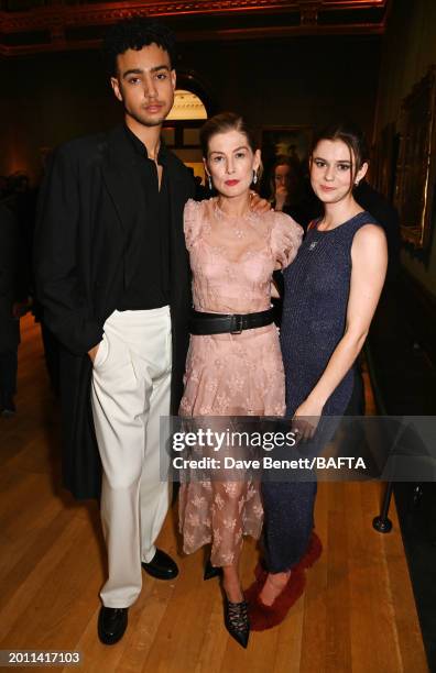 Archie Madekwe, Rosamund Pike and Alison Oliver attend the Nominees' Party for the EE BAFTA Film Awards 2024, supported by Bulgari at The National...