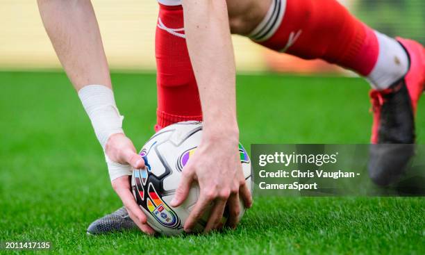 Lincoln City's Sean Roughan picks up a rainbow coloured PUMA Orbita official Sky Bet EFL match ball during the Sky Bet League One match between...