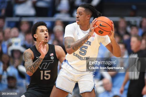 North Carolina Tar Heels forward Armando Bacot looks to pass as Virginia Tech Hokies center Lynn Kidd defends during the college basketball game...