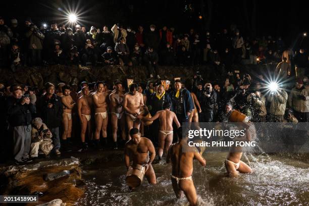 Men cleanse their bodies in a river during the Sominsai Festival at Kokuseki-ji Temple in Oshu, Iwate Prefecture, Japan, on February 17, 2024. The...