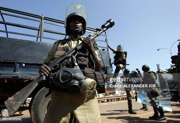 Ugandan police arrive to search for rock-throwers 25 February 2006 after dispersing with live rounds and teargas supporters of opposition leader...