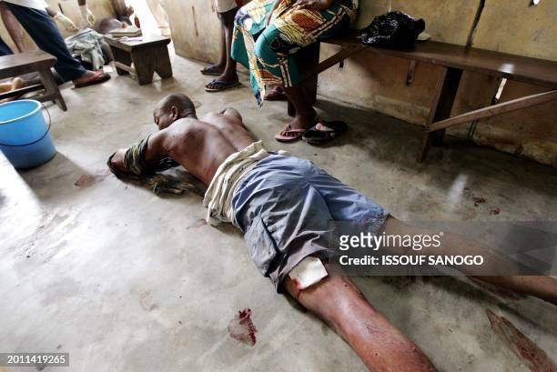 Two men lie on the ground after being injured by Togolese police forces in Lome following a demonstration called by opposition militants to protest...