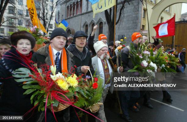 Supporters of Ukrainian pro-Western opposition leader Viktor Yushchenko march in the center of Kiev 07 December 2004, bringing flowers to Ukraine's...