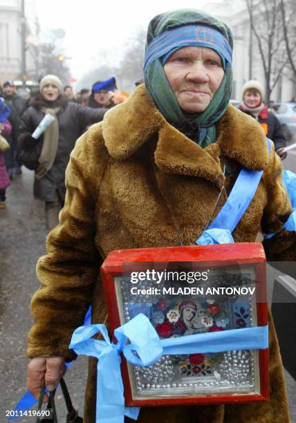 Supporter of Ukrainian Prime Minister and pro-Russian presidential candidate Viktor Yanukovich carries an icon while marching in central Kiev 02...