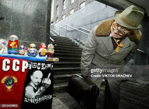 Man looks at Soviet era souvenirs, placed on a stand in an underground passage in Kiev, 19 November 2004. Ukraine is bracing itself for the most...