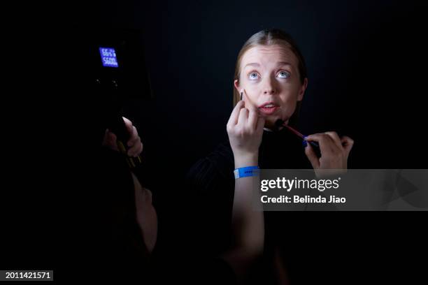 Models prepare backstage ahead of the Ukraine Fashion Week show presented during London Fashion Week February 2024 at BFC Show Space, The Old...