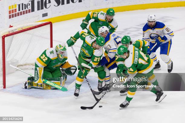 The Minnesota Wild and the Buffalo Sabres battle for the puck during the first period of an NHL game between the Buffalo Sabres and Minnesota Wild on...