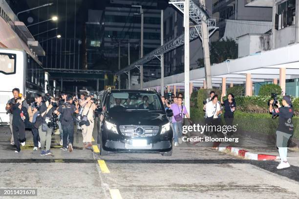 Thaksin Shinawatra, Thailand's former prime minister, right back seat, leaves in a vehicle from Police General Hospital with his daughter Paetongtarn...