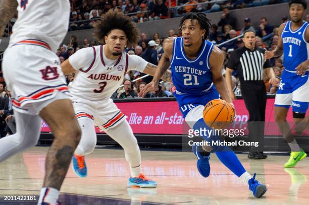 Wagner of the Kentucky Wildcats looks to maneuver the ball by Tre Donaldson of the Auburn Tigers during the first half of play at Neville Arena on...