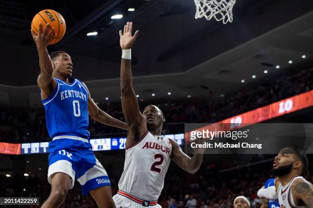 Rob Dillingham of the Kentucky Wildcats looks to pass the ball in front of Jaylin Williams of the Auburn Tigers during the first half of play at...