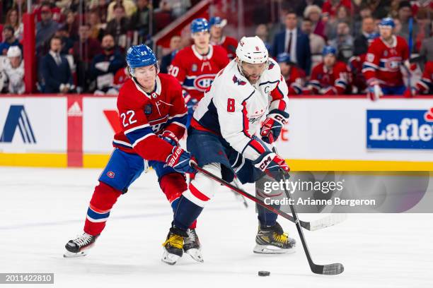 Alex Ovechkin of the Washington Capitals skates with the puck under pressure from Cole Caufield of the Montreal Canadiens during the first period of...