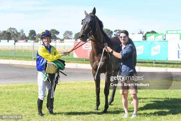 John Allen with trainer Thomas Sadler after their horse Poetic Whisper won the TAB 0-58 Handicap at Werribee Racecourse on February 18, 2024 in...