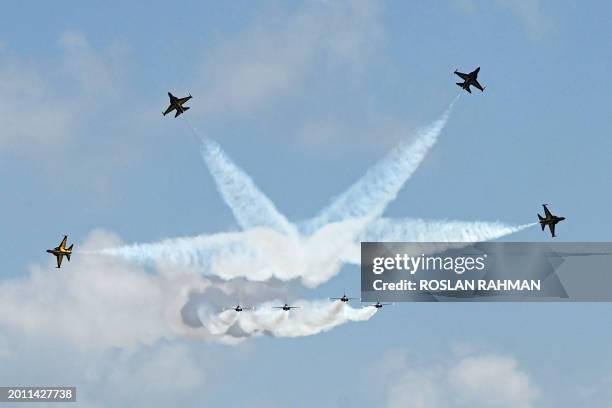 Members of South Korea's 'Black Eagle' aerobatics team perform during a preview of the Singapore Airshow in Singapore on February 18, 2024.