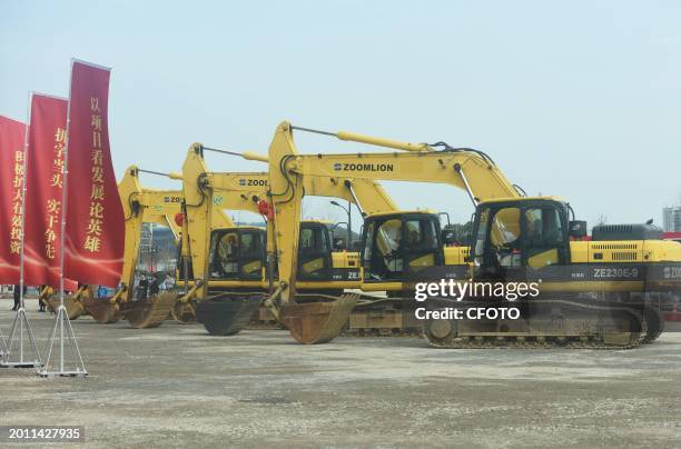Construction workers drive an excavator to start construction of the main campus of the Hangzhou Institute for Advanced Studies at the University of...