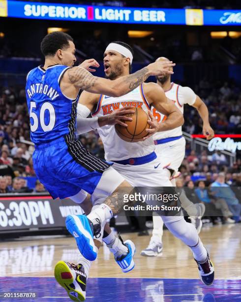 Cole Anthony of the Orlando Magic fouls Josh Hart of the New York Knicks during the first quarter at Kia Center on February 14, 2024 in Orlando,...