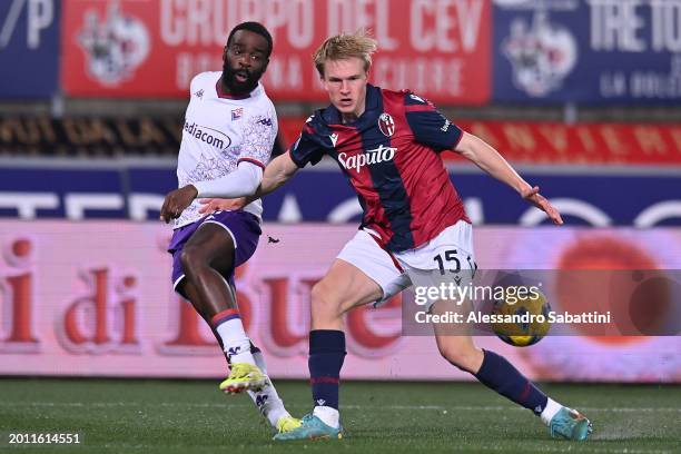 Victor Kristiansen of Bologna FC competes for the ball with Jonathan Ikoné of ACF Fiorentina during the Serie A TIM match between Bologna FC and ACF...